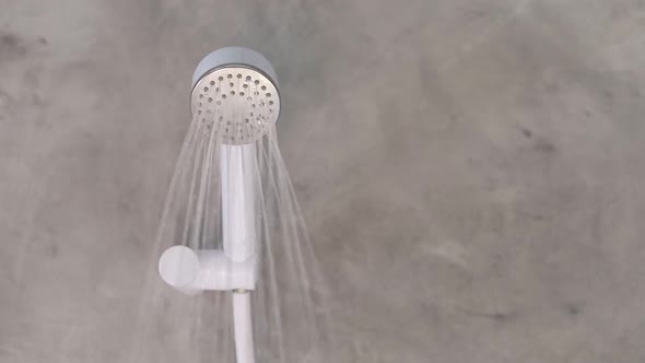 Turn on the shower water in the bathroom.