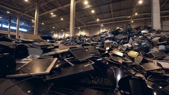 Discarded Screens in a Pile in a Recycling Facility. alt