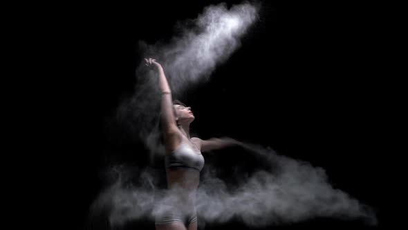Beautiful Girl Throwing Dust Slow Motion Video in the Dark