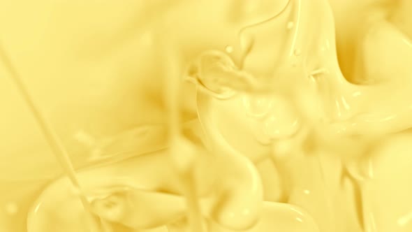 Super Slow Motion Shot of Pouring and Splashing Vanilla Milk at 1000Fps alt