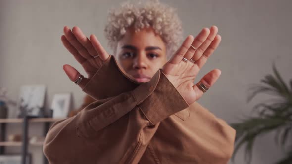Serious Young African American Beautiful Woman Cross Her Hands Showing Stop Sign alt