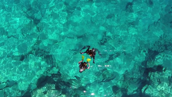 Aerial View of Divers Swimming Underwater Sea alt