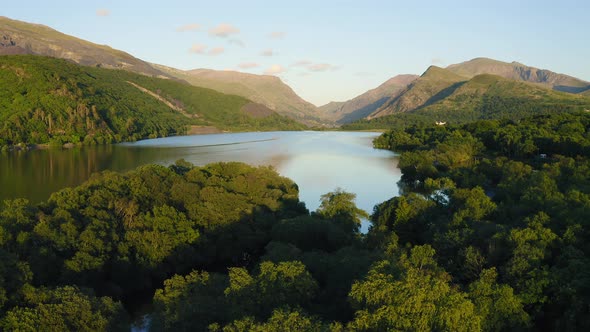 Beautiful landscape of Llyn Padarn Lake surrounded by lush forest and mountains in Snowdonia Nationa alt