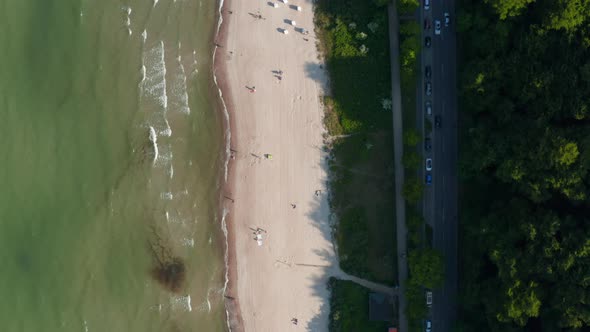 Aerial Birds Eye Overhead Top Down View of Baltic Sea Coastline Beach with People Walking on Shore alt