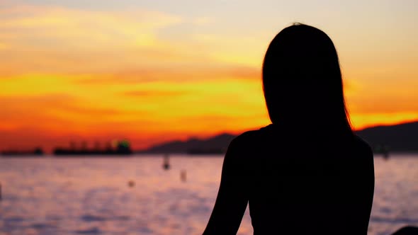 Woman performing yoga on the beach alt