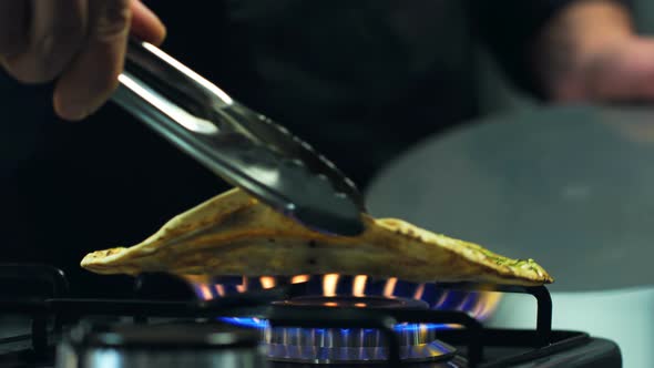 Chef Cooks Pita Bread On The Gas Fire Plate alt