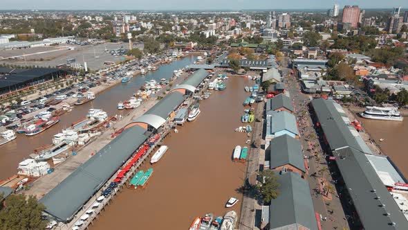 Aerial establishing shot of Puerto de Frutos, a touristic market in Tigre city, Argentina alt