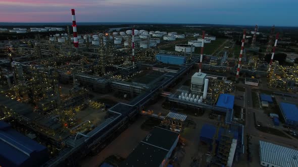 Aerial view of the petrochemical oil refinery plant shines at night alt
