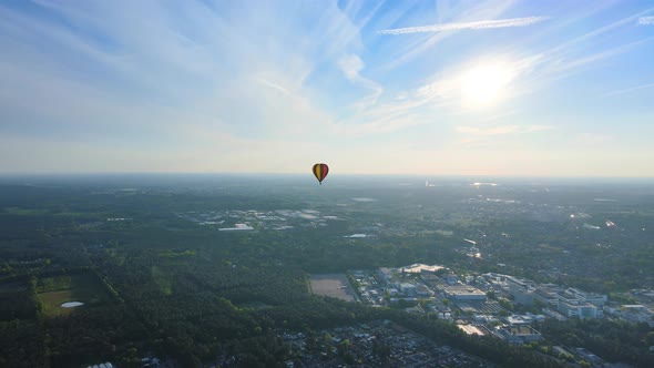 Flying away from air ballon in summer above residential area