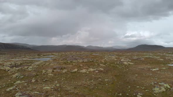 Hardangervidda wilderness with glacier mountainside behind, Norway, aerial view alt