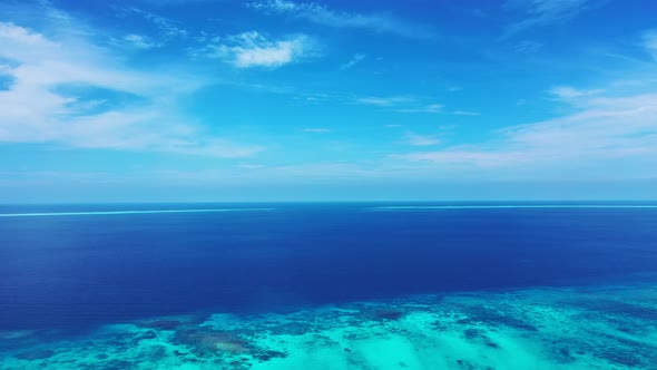 Natural flying island view of a white paradise beach and blue sea background in 4K alt