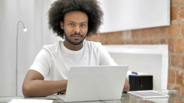African Man in Office Looking at Camera alt
