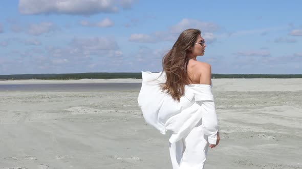 Beautiful Woman Walking on Shore