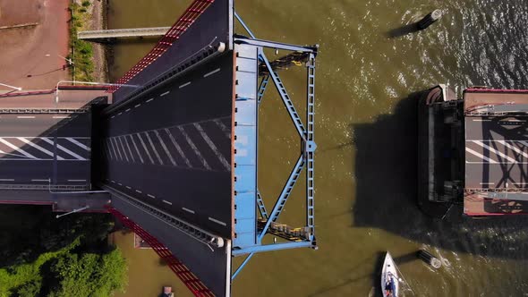 Single-leaf Bascule Bridge Opening Over River Noord With Sailboats Passing By In Alblasserdam, Nethe alt