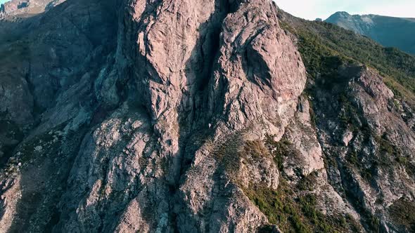 rocky mountain peaks with clear blue skies. flight over a National Park Los Bellotos.  green vegetat alt