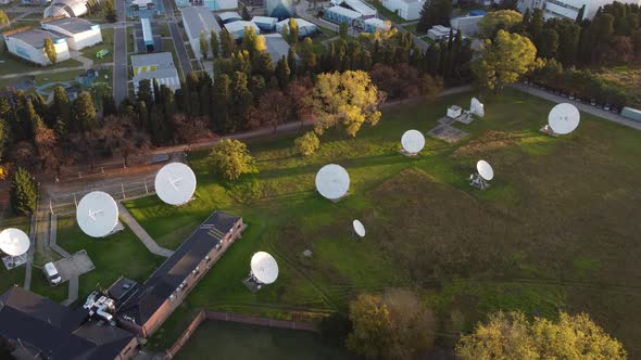 Aerial orbit shot of many satellites of research center connecting outdoors alt