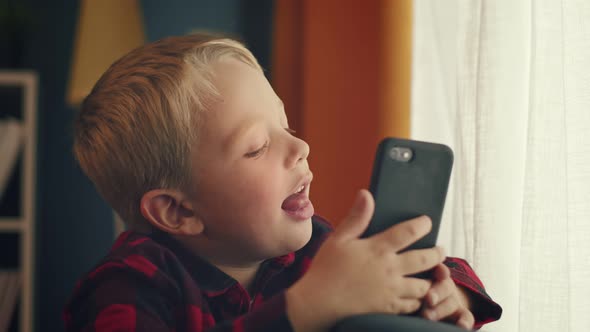Caucasian Preschooler Smiling Posing in Front of the Camera While Making Photos alt