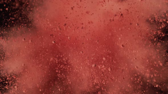 Powder exploding against black background. Slow Motion. Unedited version included. alt