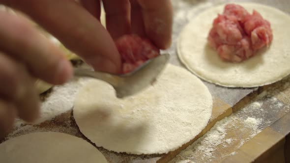 Add Minced Meat To a Piece of Dough, Close Up.