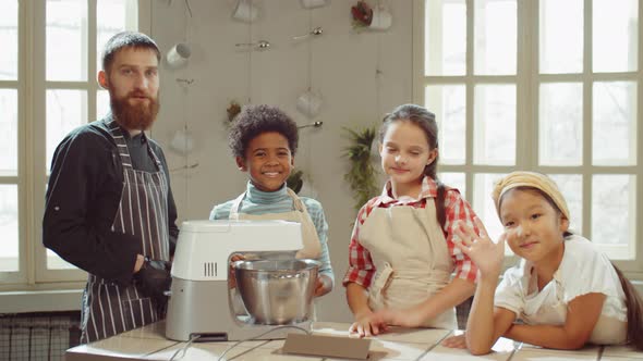 Portrait of Chef and Cheerful Kids on Cooking Masterclass alt