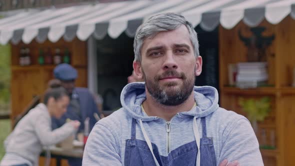 Portrait of caucasian owner small business near his food booth