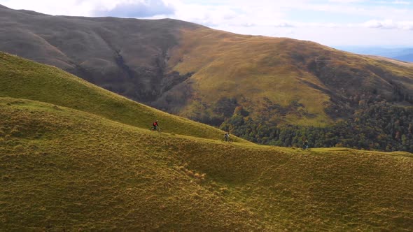 Trail bikers ride on off road trail by mountain bike in autumn. Friends riding mountain bike  alt