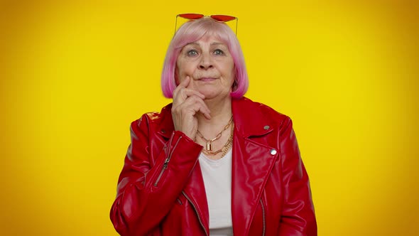 Thoughtful Clever Senior Old Grandma Woman Rubbing Her Chin Pondering a Solution Doubting Question alt