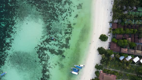 Top down of white sand beach and coral reef in Koh Lipe Thailand, aerial alt