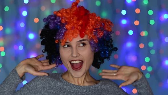Woman in Colored Afro Wig Having Fun