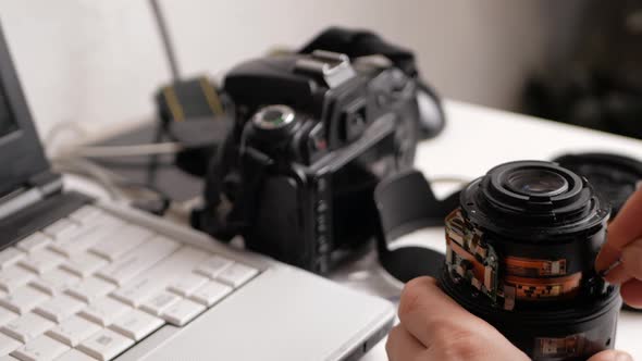 Man Repairs Camera Lens Autofocus Motor Tools