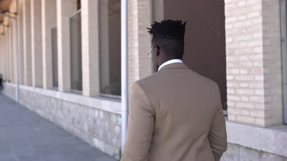Stylish black model walking in building alt