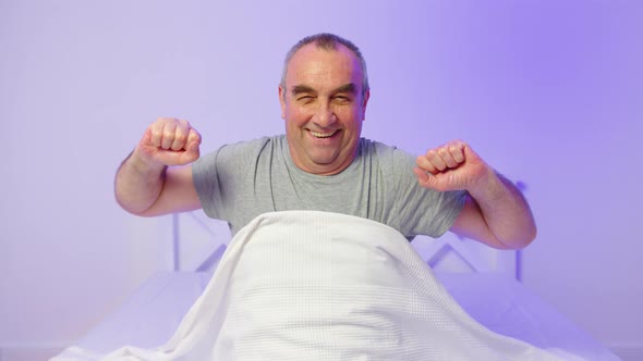 Handsome Senior Man Waking Up in Good Mood at Home After Nice Calm Night alt