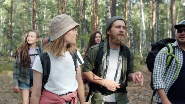 Group of Friends Young People Walking in Woods Talking Smiling Enjoying Trip Outdoors alt