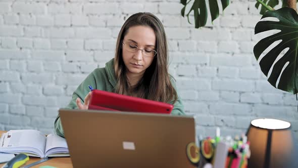 Serious White Girl Student in Glasses Typing on Laptop Preparing Course Work alt