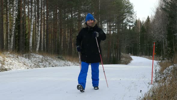 Young Man Does Sport, Fitness, Nordic Walking And Exercising Outdoors, Winter Forest, Countryside. alt