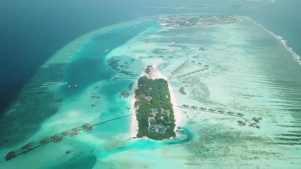 Aerial Drone View of a Beautiful Atoll or Island with a Resort in the Maldives alt