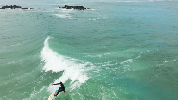 Aerial Shot Male Surfer Catches and Ride a Massive Barreling Waves alt