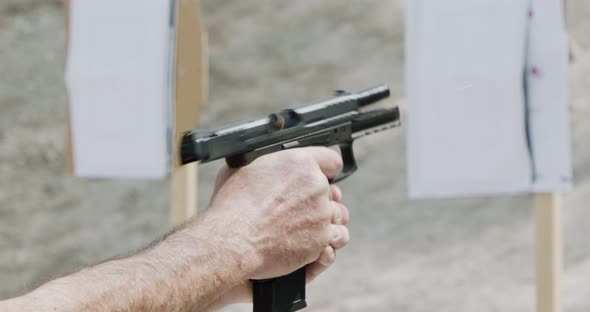 Pistol shooting bullets in slow motion footage. Hand guns in firing range