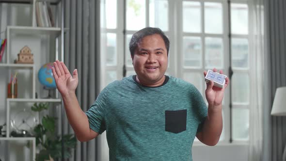 Asian Man Blogger Shoots Video Content For Social Networks, Magician With Playing Cards alt