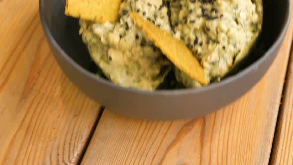 Delicious Raw Food Snack with Green Leaves and Yellow Crisps alt