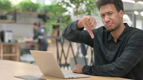 Thumbs Down Sign By African American Man with Laptop alt