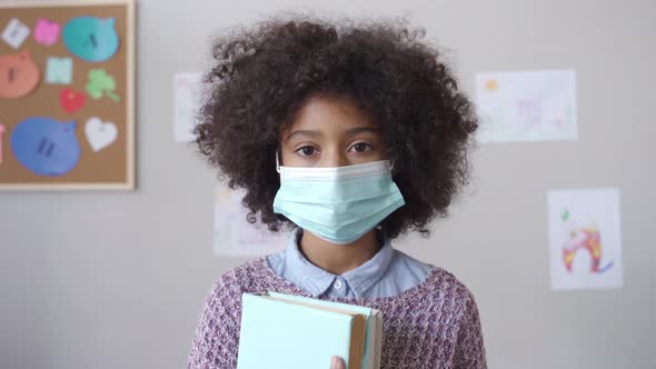 African School Child Girl Wearing Face Mask in Classroom Headshot Portrait alt