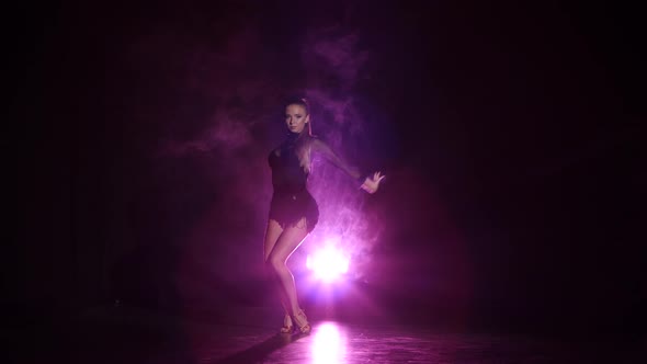 Dancer Rumba in Studio with Purple Lighting, a Dark Background alt