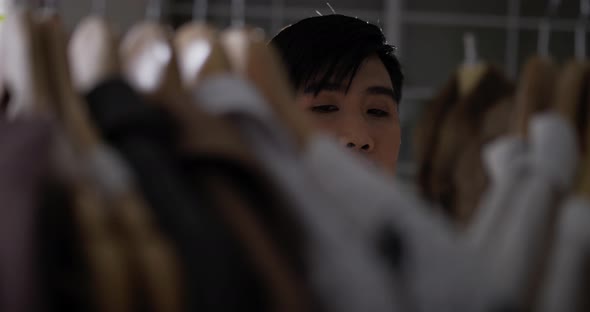 Close up clothes of Fashion designer or stylist manage new clothes collection on rack alt