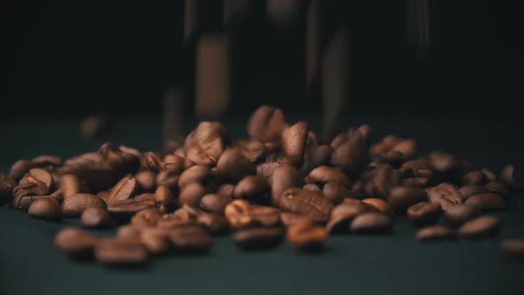 Closeup of Mocha Coffee Beans Fall and Bounce on the Table alt