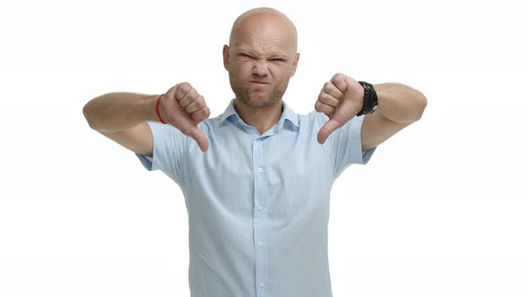 Middleaged of Bald Bearded Man in Blue Shirt Telling No Shaking Head and Grimacing Showing alt