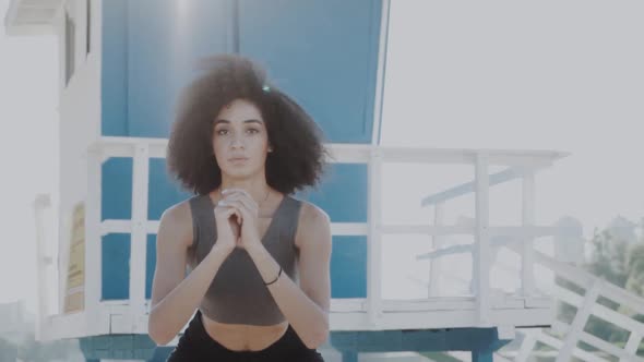 Fitness Young Woman Working Out with Fitness Rubber, Doing Squat Exercises on Beach. Concept of alt