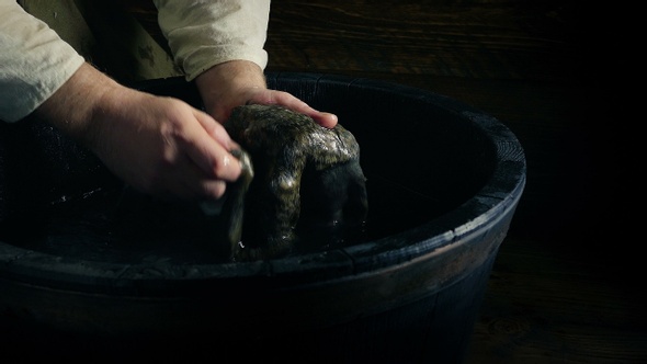Man Washes Animal Fur In Tub History Scene alt