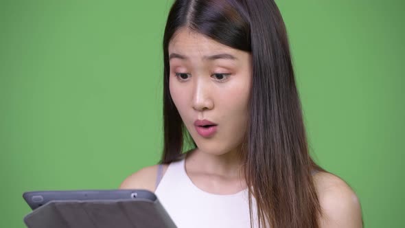 Young Beautiful Asian Businesswoman Using Digital Tablet