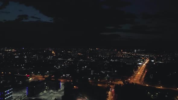 Aerial view of the streets of the city at night with Roundabout road junction 09 alt